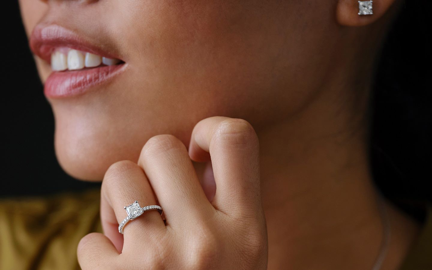 Close up of woman's natural princess-cut diamond engagement ring 