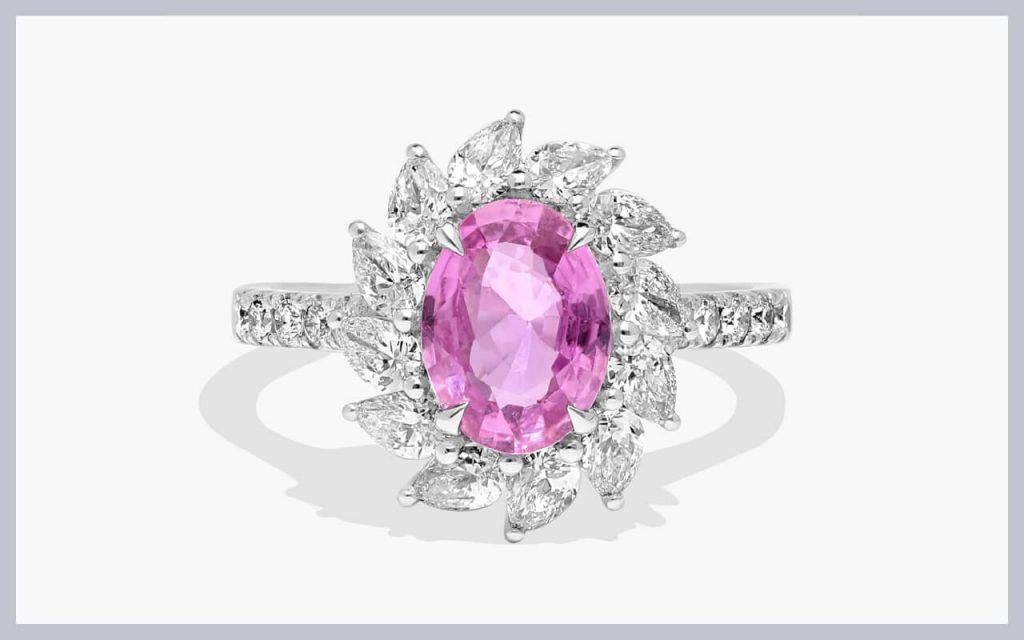 Vivid pink sapphire framed by marquise and round stones, a standout choice for unique stones for engagement rings