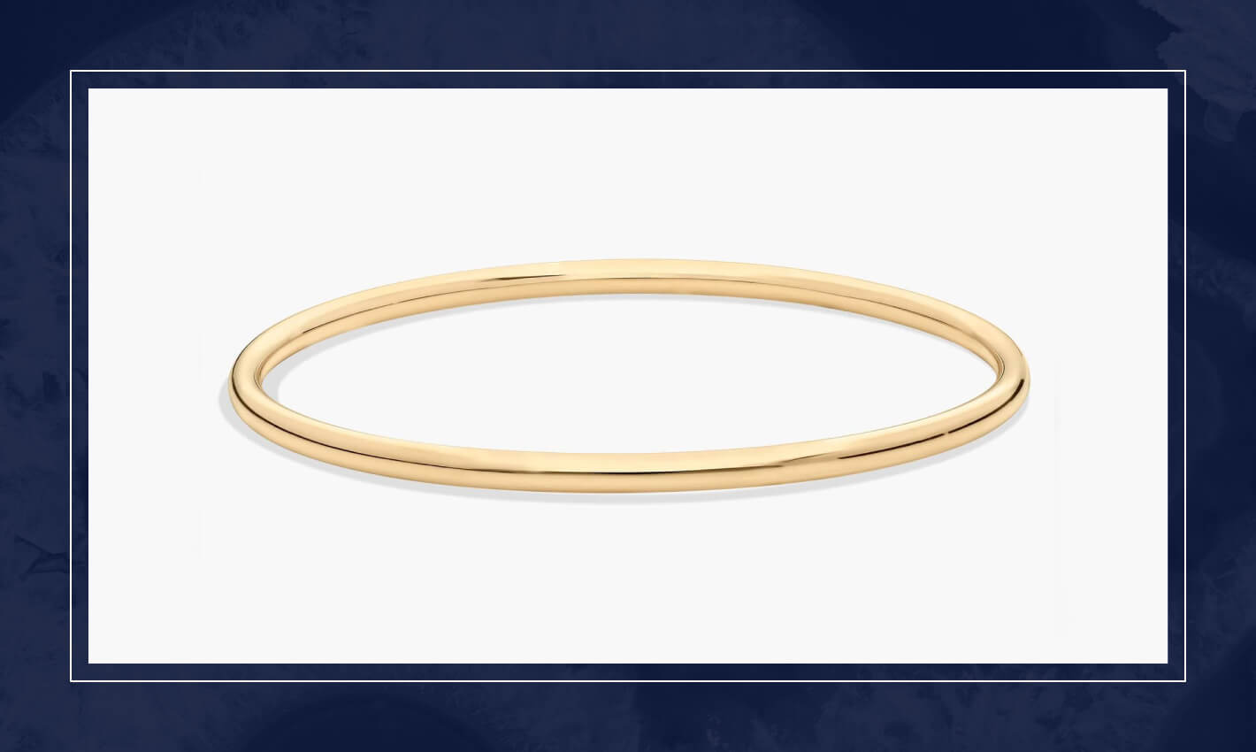 Polished yellow gold bangle bracelet with a smooth rounded profile, offering a minimalist design that layers easily with other pieces.