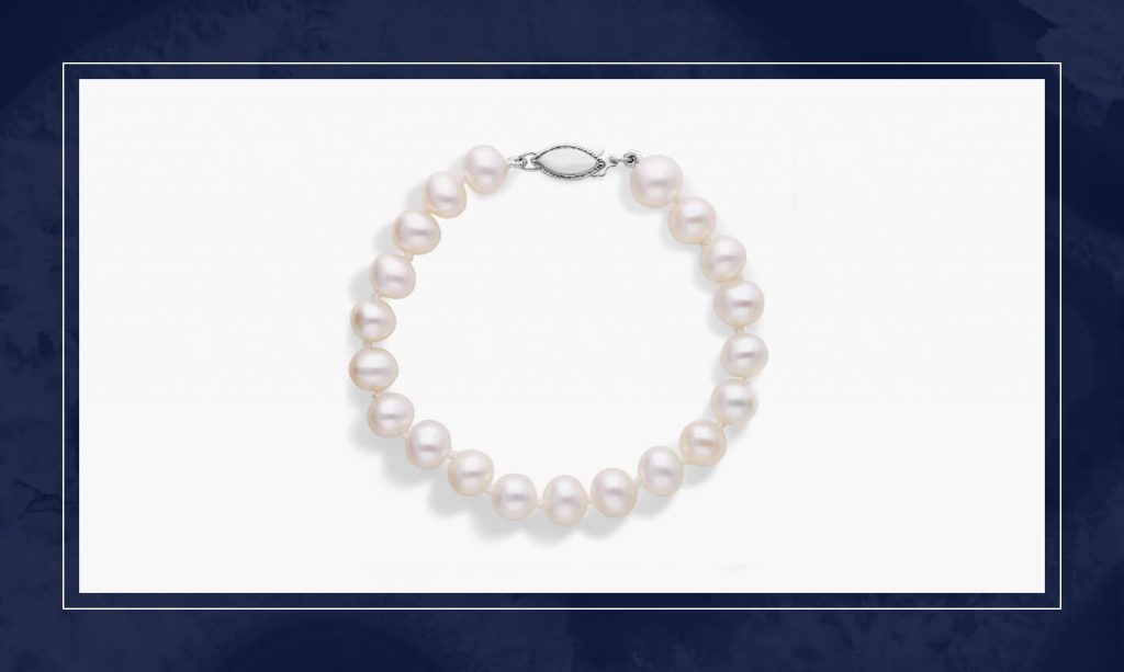 Freshwater pearl bracelet with evenly spaced round pearls and a white gold clasp, creating a soft, refined style with natural luster.
