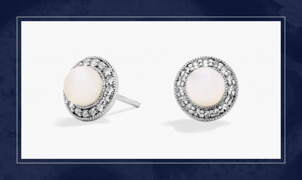 Round pearl stud earrings framed by a diamond halo in white gold, blending classic elegance with subtle sparkle and texture.