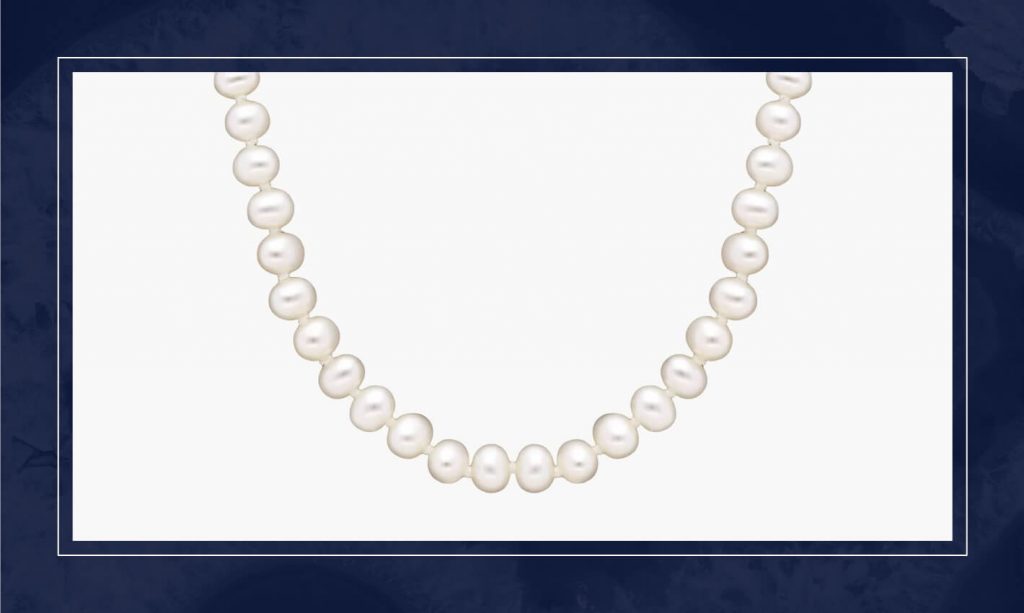 Classic pearl strand necklace featuring uniform round pearls, designed to sit gracefully at the collarbone with a timeless finish.