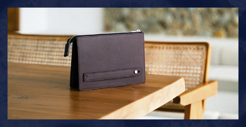 A dark purple bag rests on a wooden table.