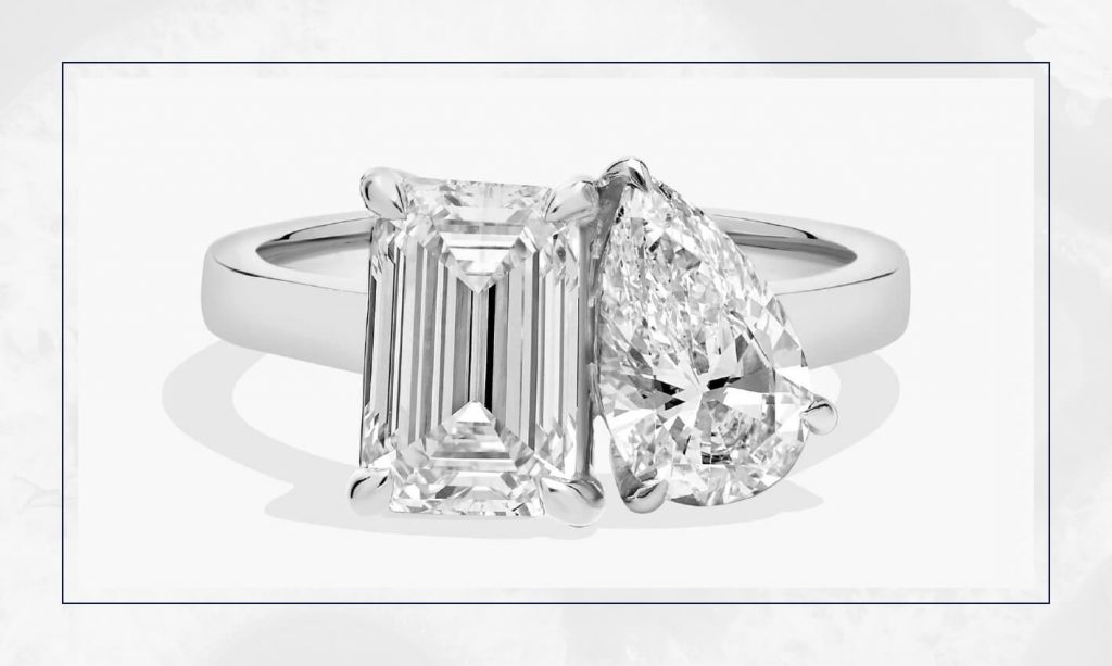 Modern two-stone ring pairing emerald-cut and pear-shaped diamonds, showing one of the most talked-about trending engagement rings