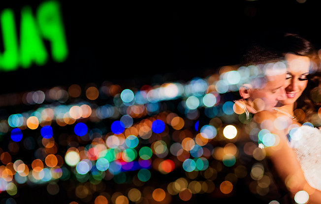 A couple standing under The Palms casino sign in Las Vegas