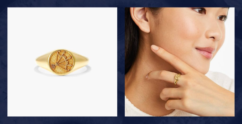 Woman wears gold zodiac ring.